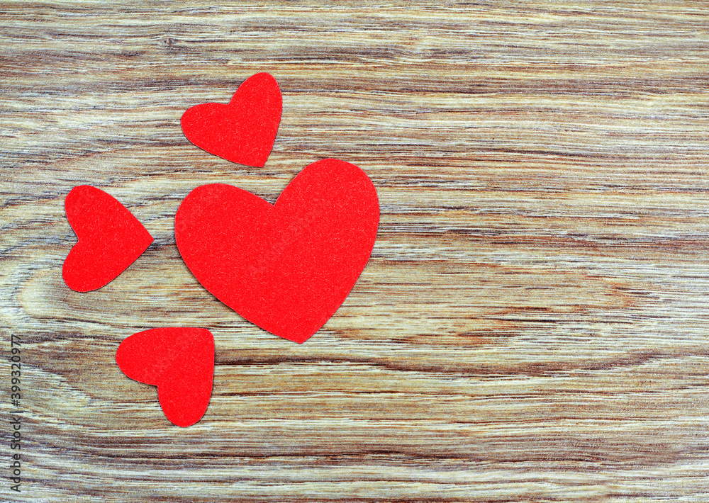 Red hearts on a wooden background. Paper hearts. Red hearts on a wooden background. Paper hearts.