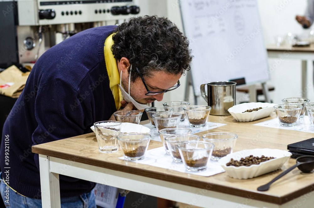 Professional barista testing the smell of a new coffee Professional barista testing the smell of a new coffee