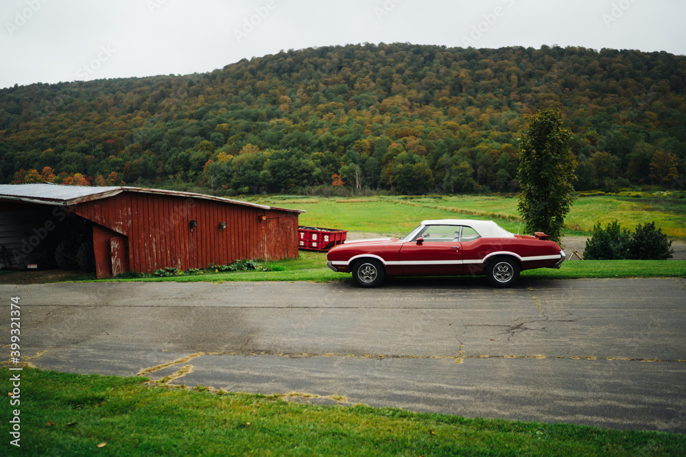 Fototapeta premium Vintage American car near green hill