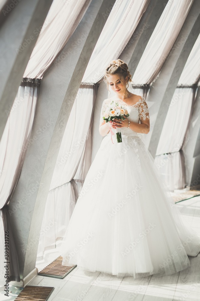 Portrait of stunning bride with long hair posing with great bouquet Portrait of stunning bride with long hair posing with great bouquet