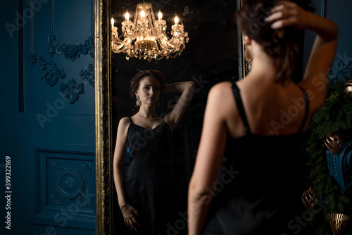 Awesome woman looking to the her reflection in the mirror