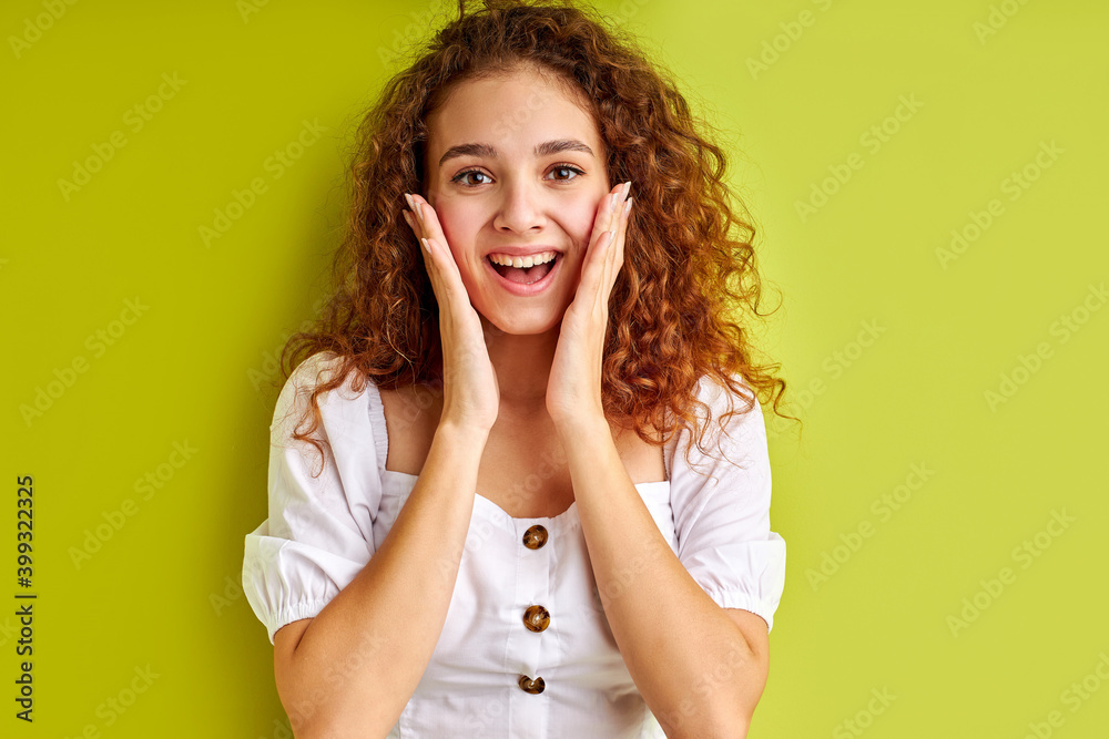 amazed crazy caucasian girl in shock, isolated over green background. young female with curly hair emotionally reacts on something amazed crazy caucasian girl in shock, isolated over green background. young female with curly hair emotionally reacts on something
