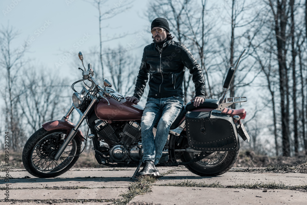 Obraz premium Biker portrait. Photo with a motorcycle