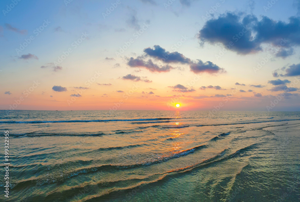 Beautiful turquoise waves at sunset. Seaside.