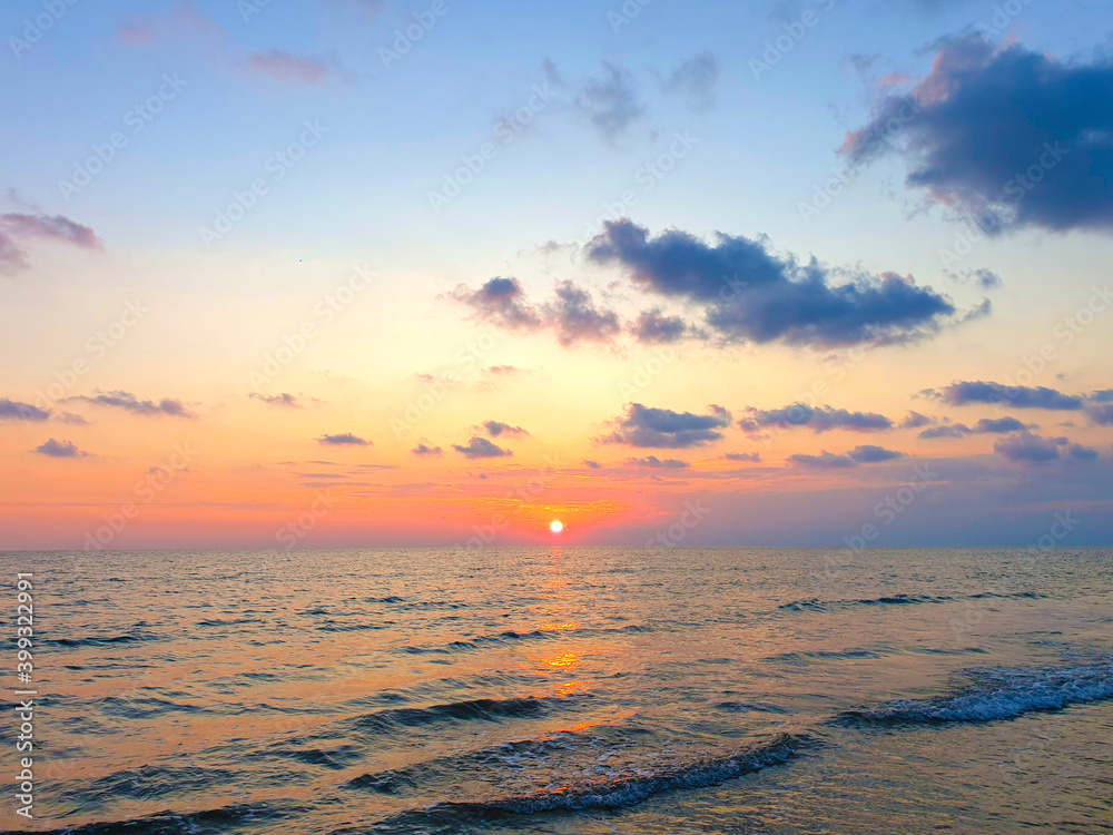 Sea sunset. The sun sets over the horizon of the sea.