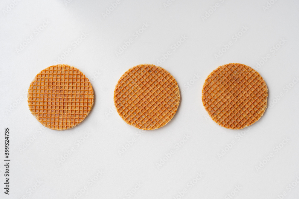 caramel holland waffles standing next to each other on white background. creative loading design. caramel holland waffles standing next to each other on white background. creative loading design.