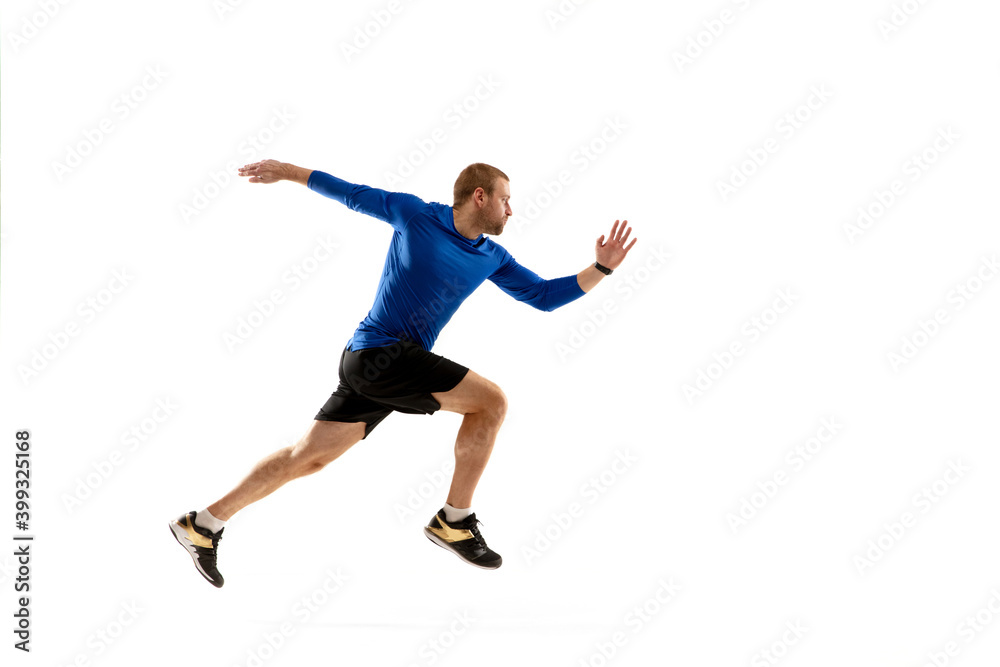 High. Caucasian professional jogger, runner training isolated on white studio background. Muscular, sportive man, emotional. Concept of action, motion, youth, healthy lifestyle. Copyspace for ad.