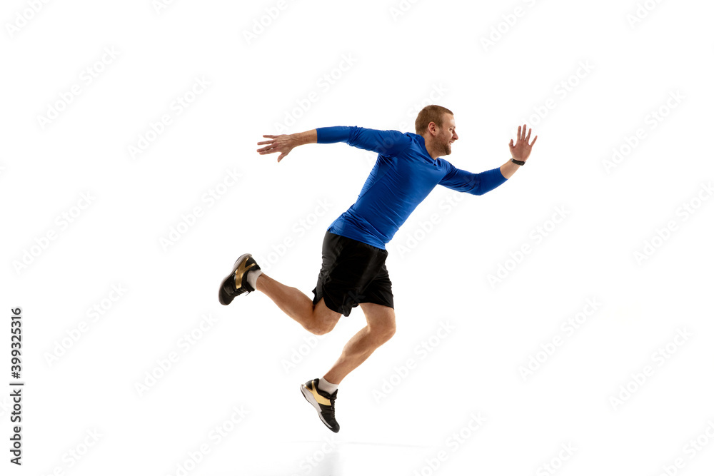 High. Caucasian professional jogger, runner training isolated on white studio background. Muscular, sportive man, emotional. Concept of action, motion, youth, healthy lifestyle. Copyspace for ad.