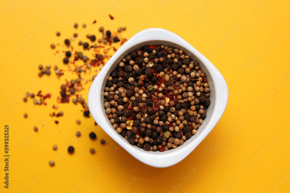 Black pepper in white bowl on brown wood background with copy space. Healthy eating, ayurveda, naturopathy concept Black pepper in white bowl on brown wood background with copy space. Healthy eating, ayurveda, naturopathy concept
