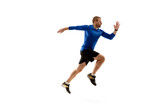 Win. Caucasian professional jogger, runner training isolated on white studio background. Muscular, sportive man, emotional. Concept of action, motion, youth, healthy lifestyle. Copyspace for ad.