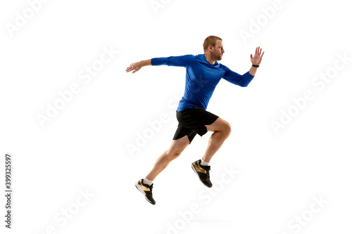 Win. Caucasian professional jogger, runner training isolated on white studio background. Muscular, sportive man, emotional. Concept of action, motion, youth, healthy lifestyle. Copyspace for ad. © master1305