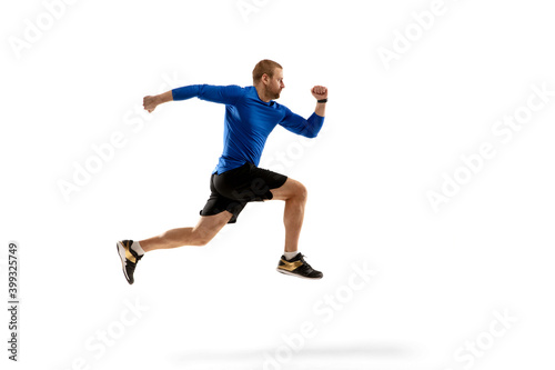 Win. Caucasian professional jogger, runner training isolated on white studio background. Muscular, sportive man, emotional. Concept of action, motion, youth, healthy lifestyle. Copyspace for ad.