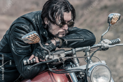 Biker portrait. Photo with a motorcycle © algrigo