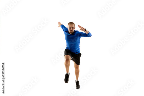 Achievement. Caucasian professional jogger, runner training isolated on white studio background. Muscular, sportive man, emotional. Concept of action, motion, youth, healthy lifestyle. Copyspace for
