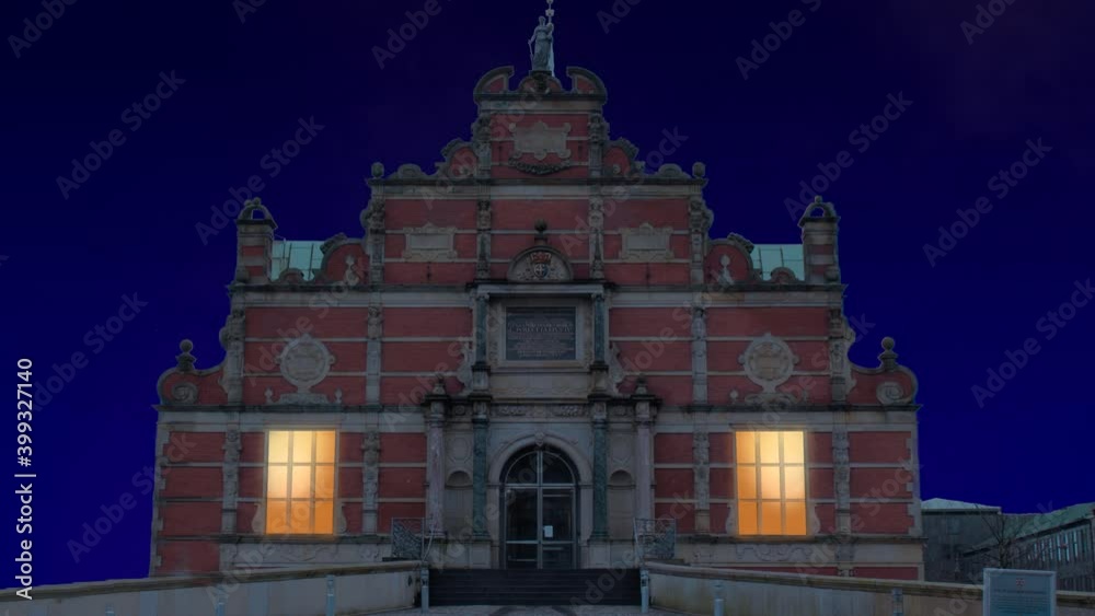 Celebratory fireworks for new year over The Borsen, Oldest Building in Slotsholmen, in Copenhagen, Denmark with the famous dragon spire up roof during last night of year. Christmas blue atmosphere