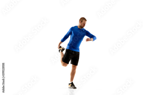 Prepares. Caucasian professional jogger, runner training isolated on white studio background. Muscular, sportive man, emotional. Concept of action, motion, youth, healthy lifestyle. Copyspace for ad. © master1305