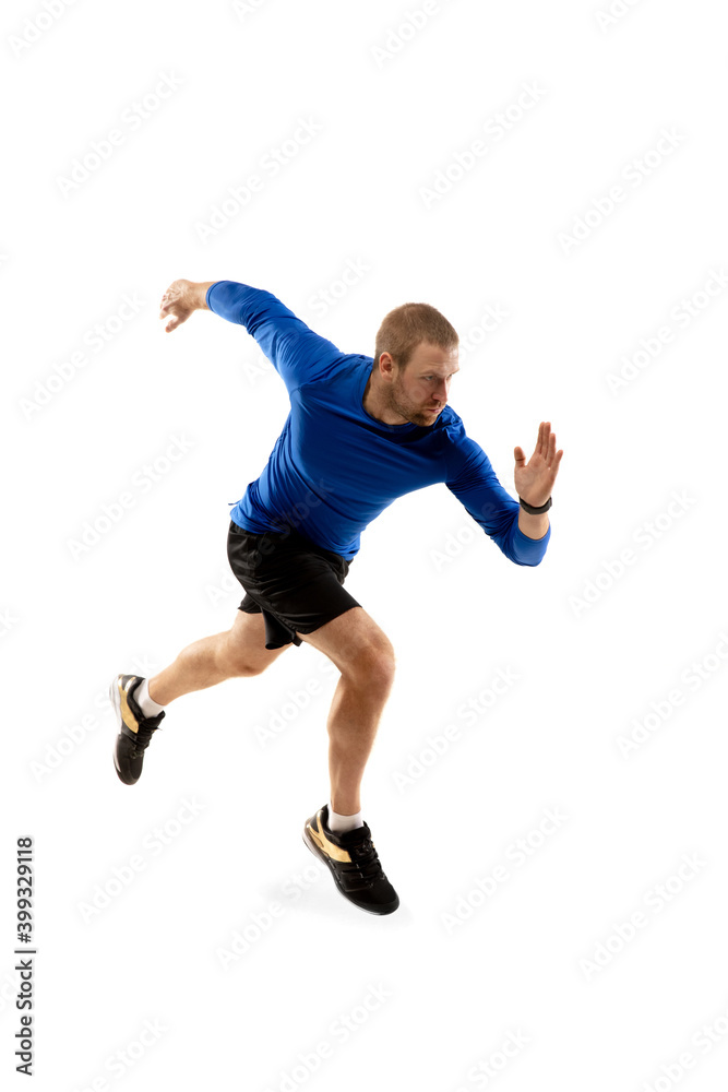 Fototapeta Power. Caucasian professional jogger, runner training isolated on white studio background. Muscular, sportive man, emotional. Concept of action, motion, youth, healthy lifestyle. Copyspace for ad.