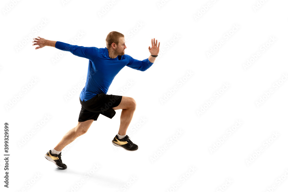Energy. Caucasian professional jogger, runner training isolated on white studio background. Muscular, sportive man, emotional. Concept of action, motion, youth, healthy lifestyle. Copyspace for ad.