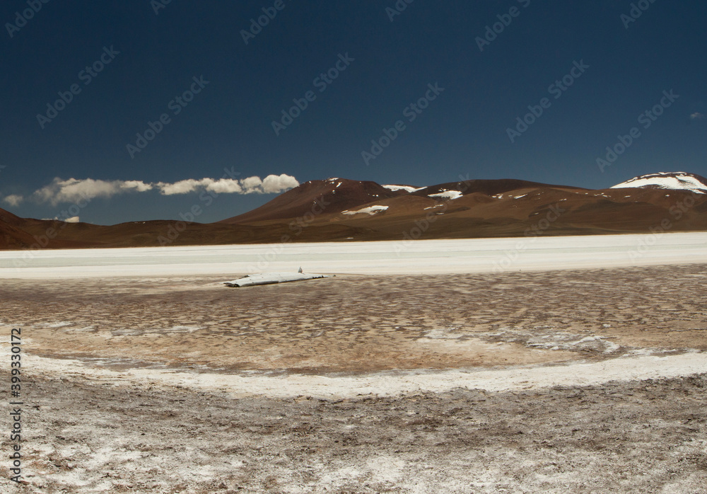 Natural salt fields in the cordillera. View of the white salt flats and brown mountains in La Rioja, Argentina. 
