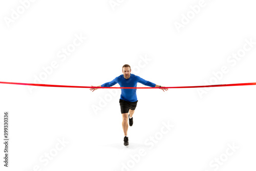 Champion. Caucasian professional jogger, runner training isolated on white studio background. Muscular, sportive man, emotional. Concept of action, motion, youth, healthy lifestyle. Copyspace for ad.
