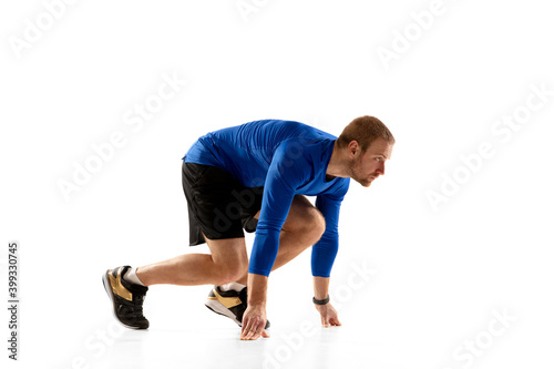 Energy. Caucasian professional jogger, runner training isolated on white studio background. Muscular, sportive man, emotional. Concept of action, motion, youth, healthy lifestyle. Copyspace for ad.
