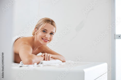 Happy smiling lady relaxing at the spa procedure in beauty center