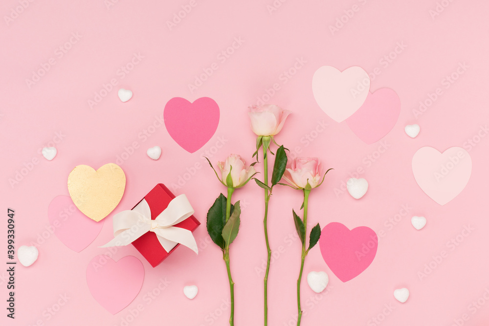  Pink paper hearts, flower rose, gift box on pastel pink background. Valentines day concept. Flat lay, top view, copy space.