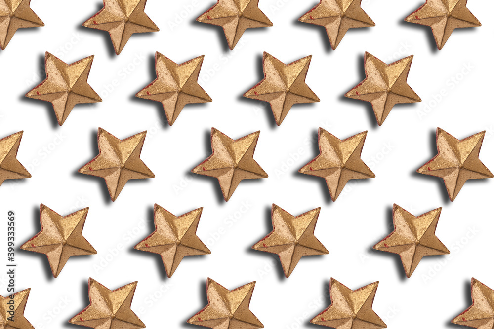 Obraz premium Gold Christmas decorations, gold star on a white background. Flat lay, top view. Christmas pattern