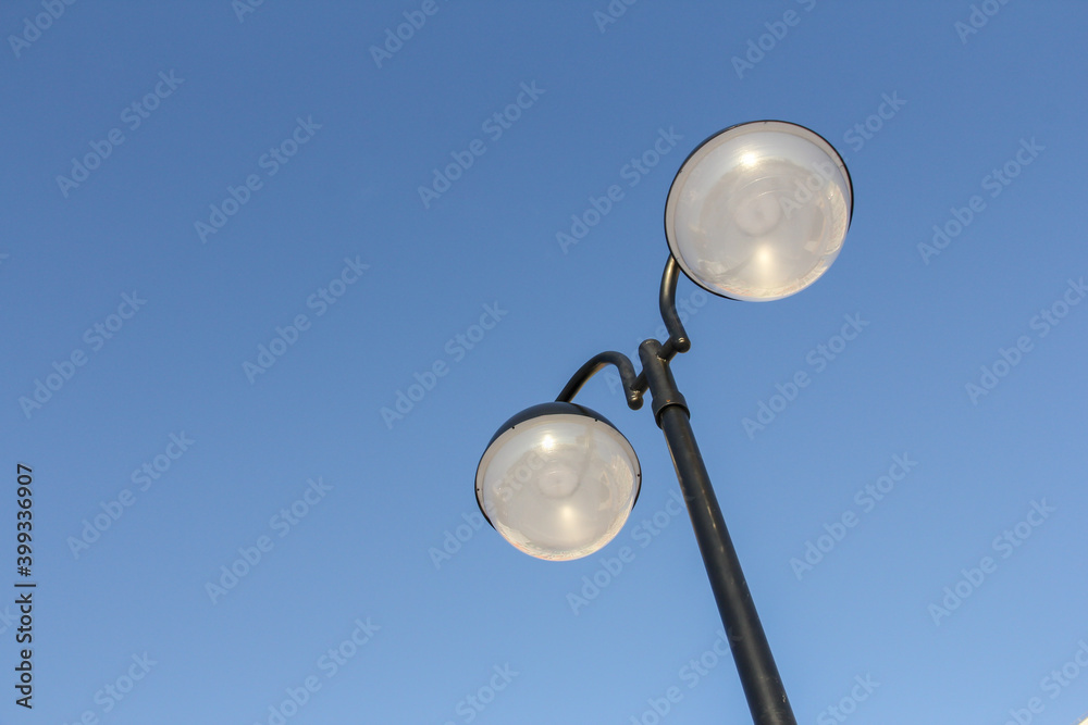 treet lamp made of two balls against the blue sky. Street lighting. treet lamp made of two balls against the blue sky. Street lighting.