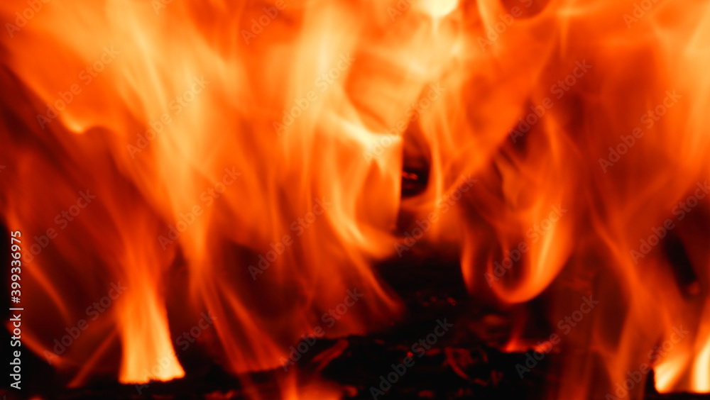 Abstract fire flame in fireplace, texture for background. Beautiful bright orange flames flicker in the darkness of the night. Abstract fire flame in fireplace, texture for background. Beautiful bright orange flames flicker in the darkness of the night.