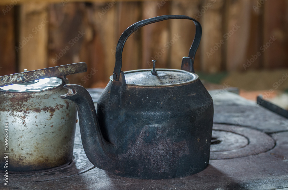Beautiful steel kettle on wood stove in the countryside Beautiful steel kettle on wood stove in the countryside