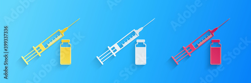 Paper cut Medical syringe with needle and vial or ampoule icon isolated on blue background. Vaccination, injection, vaccine, insulin concept. Paper art style. Vector.