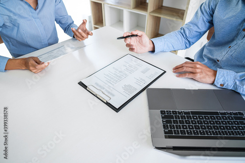 Interviewer or Board reading a resume during job interview, Employer interviewing a young male job seeker for recruitment talking in modern office and filing card, employment and recruitment concept