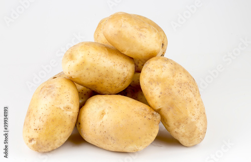 Fresh organic vegetables; potatoes on the white background.
