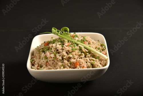 Fried rice is a dish of cooked rice that has been stir-fried in a wok or a frying pan and is usually mixed with other ingredients such as eggs, vegetables, seafood, or meat
