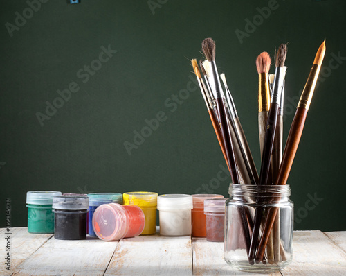 image of brushes for painting and paint on the table.