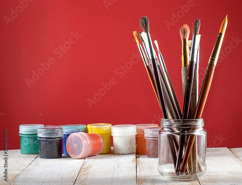 image of brushes for painting and paint on the table.