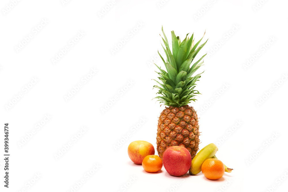 Pineapple surrounded by fruit with white background and copy space
