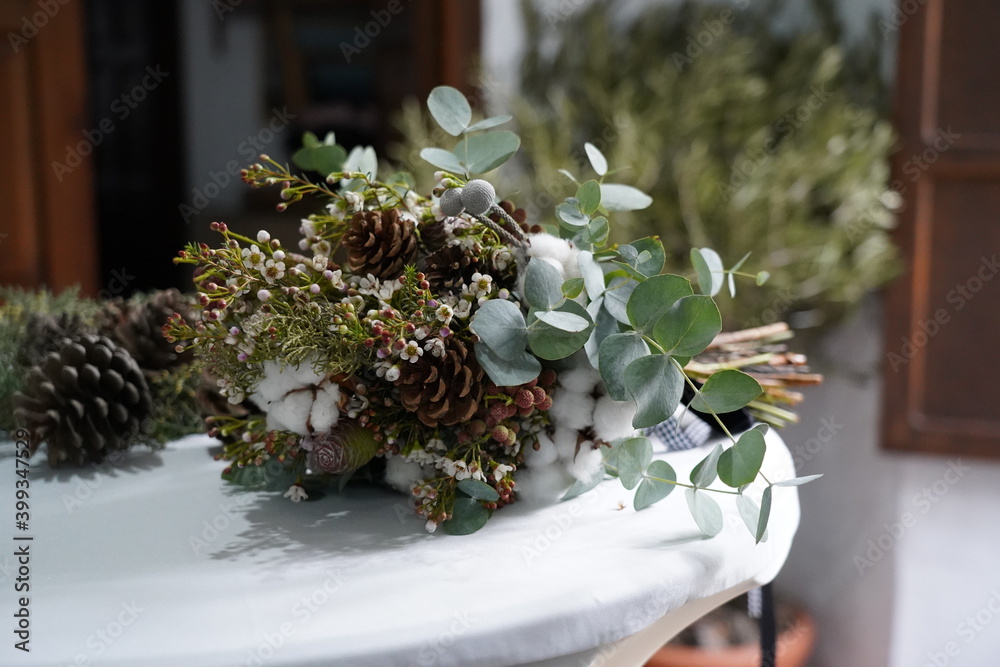 the bride's bouquet lies on a wooden stand outdoors the bride's bouquet lies on a wooden stand outdoors