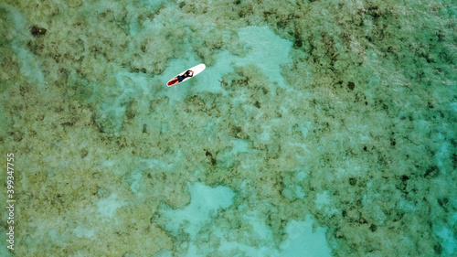 Single surfer from above, coral reef , Barbados photo