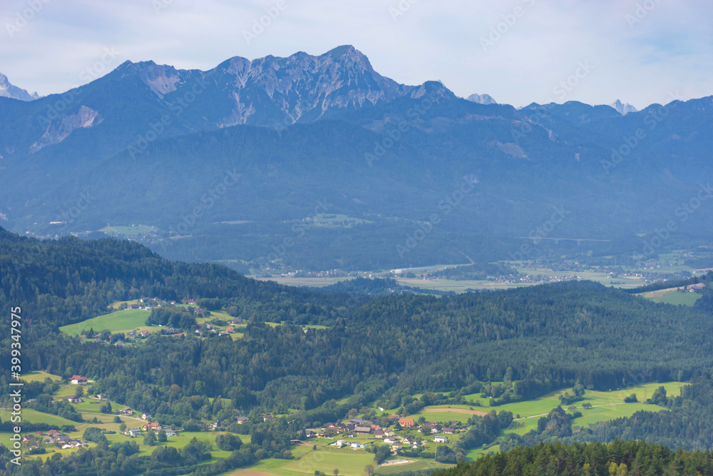 Charming village surrounded by mountains, view from The Pyramidenkogel, the highest wooden viewing tower in the world, famous tourists attraction at the lake Worthersee, Carinthia region, Austria Charming village surrounded by mountains, view from The Pyramidenkogel, the highest wooden viewing tower in the world, famous tourists attraction at the lake Worthersee, Carinthia region, Austria
