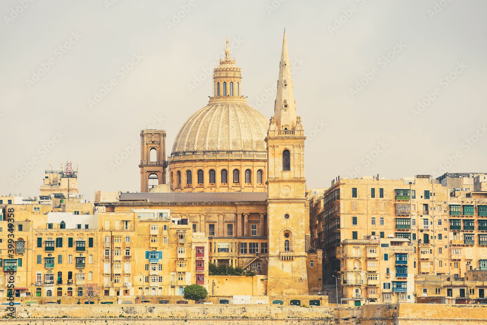 Malta, Valletta, traditional house building facade and basilica of Our Lady of Mount Carmel