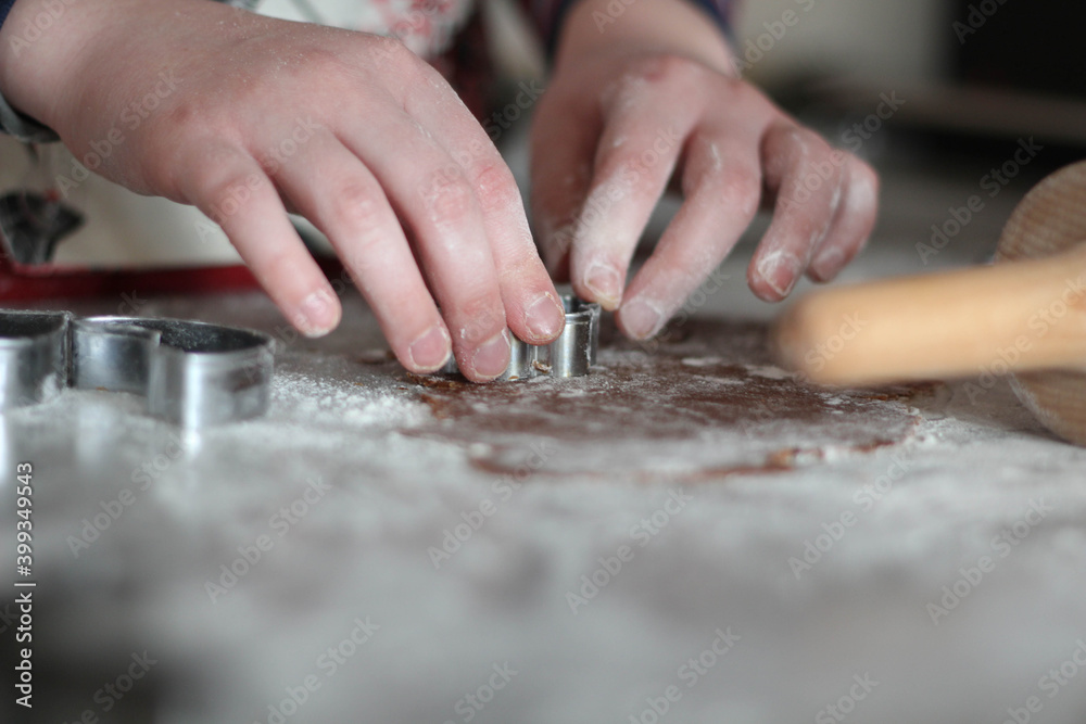 Fototapeta premium Child hands preparing homemade gingerbread cookies. Christmas time in Kitchen. Bakery