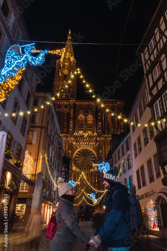 Couple in love near Strasbourg cathedral at Christmas