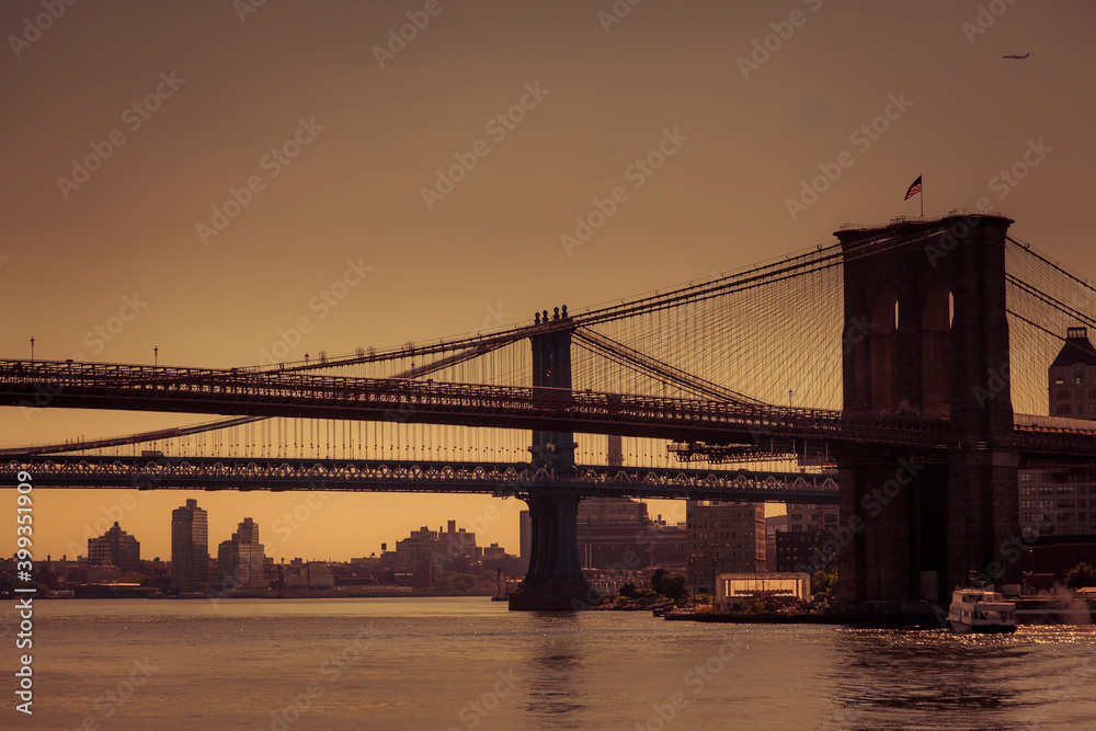 View of the famous Brooklyn bridge in silhouette at dawn