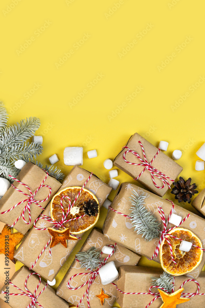 Many craft gift boxes on yellow background. Christmas banner template. New year zero waste still life