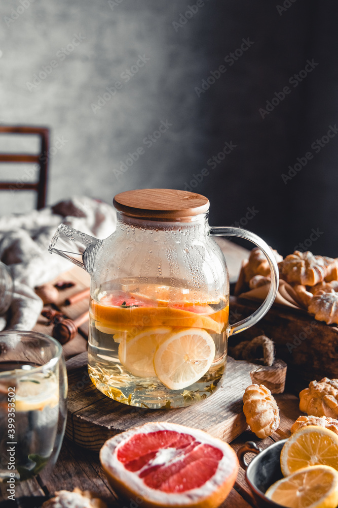 Hot tea with slices of fresh grapefruit on wooden tablet. Healthy drink, Eco, vegan Hot tea with slices of fresh grapefruit on wooden tablet. Healthy drink, Eco, vegan