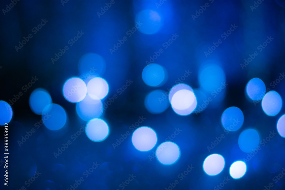 Blue bokeh, blurred background, christmas background. Neon color.
