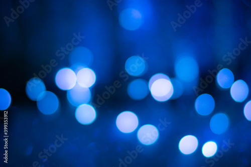 Blue bokeh, blurred background, christmas background. Neon color.