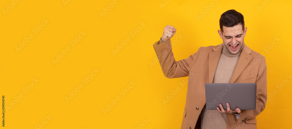successful young man with computer isolated on background successful young man with computer isolated on background